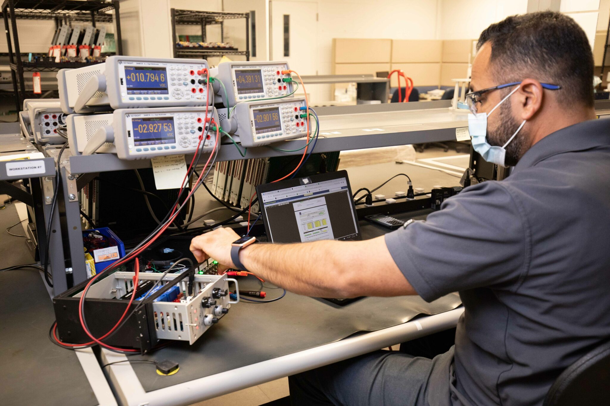 Engineer running electrical testing with precision measurement instruments